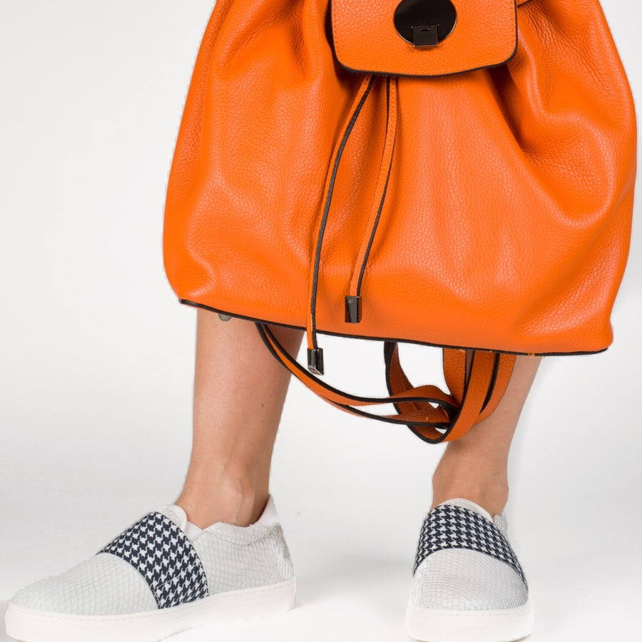 orange leather drawstring top backpack white slip on sneakers